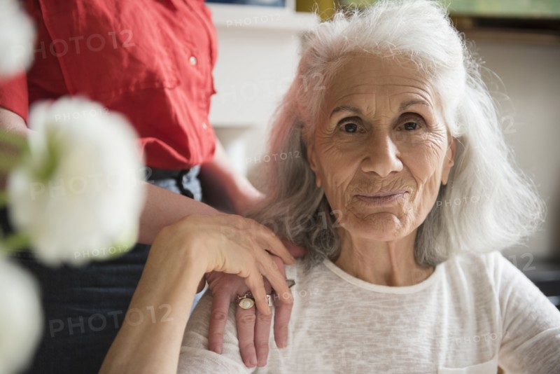 Hand of daughter on shoulder of older mother