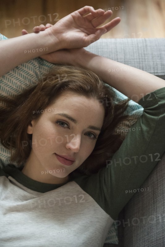 Portrait of Caucasian woman laying on sofa