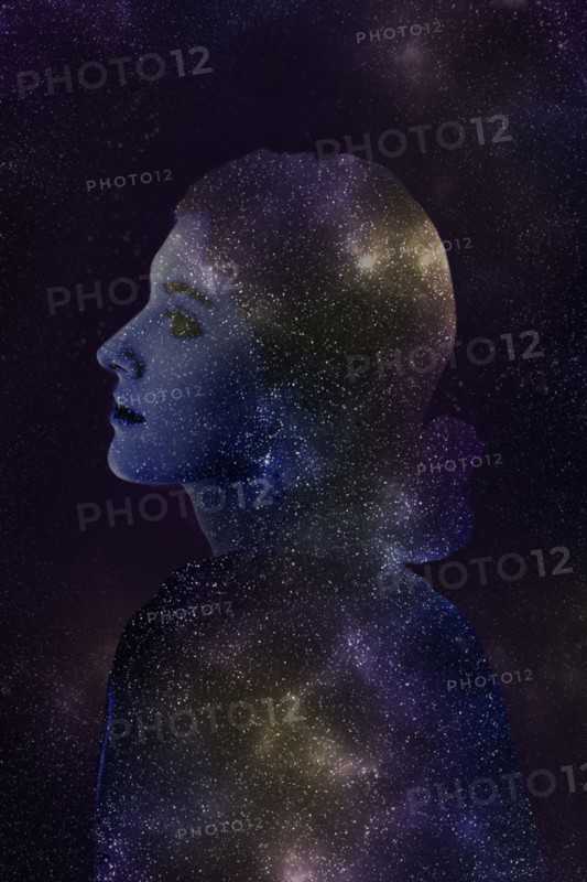Double exposure of Caucasian woman and stars in outer space