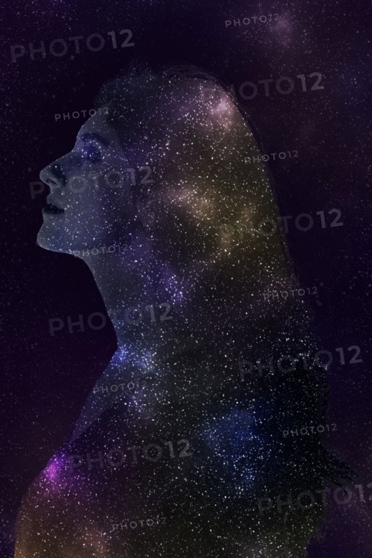 Double exposure of Caucasian woman and stars in outer space