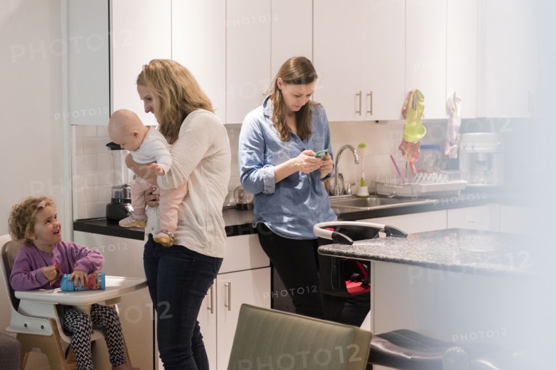 Caucasian mothers and daughters in kitchen