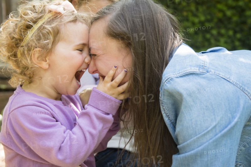 Caucasian mother and daughter laughing