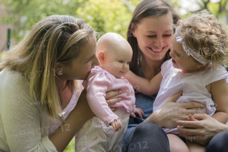Caucasian mothers and daughters playing in park
