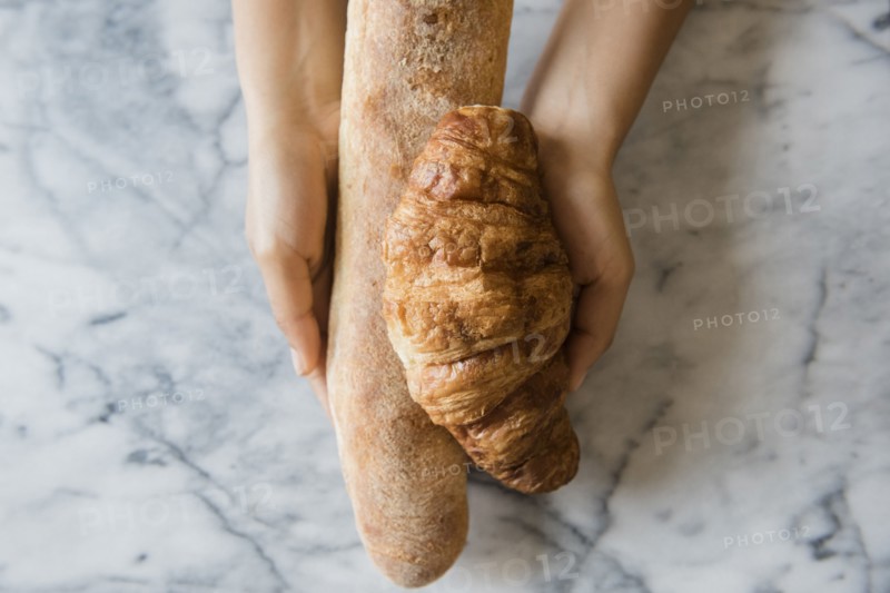 Hands of African American woman holding bread