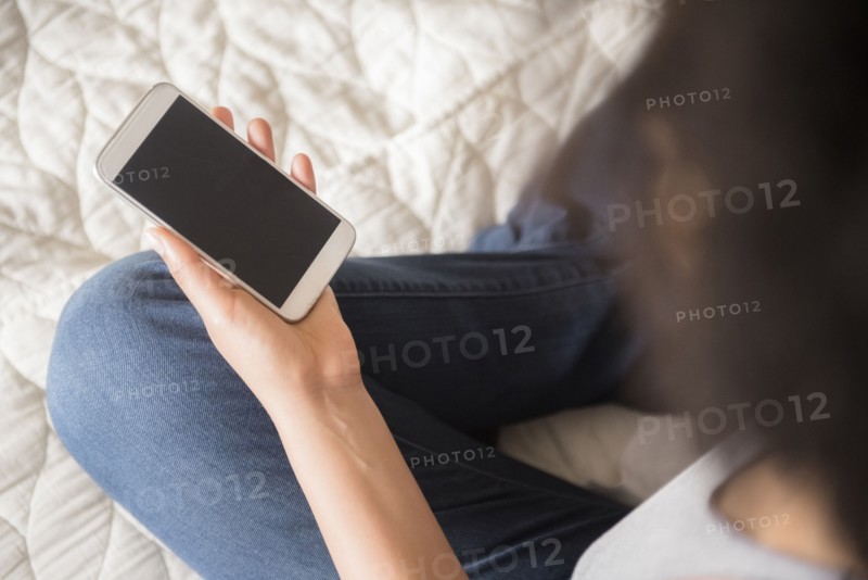 African American woman holding cell phone