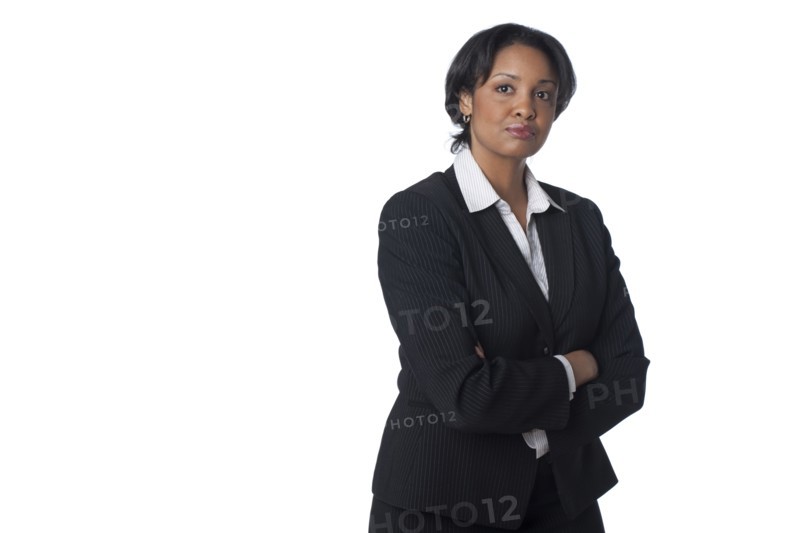 Serious mixed race businesswoman with arms crossed