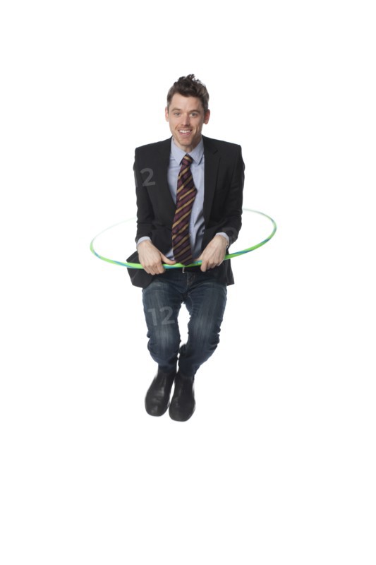 Caucasian businessman jumping plastic hoop