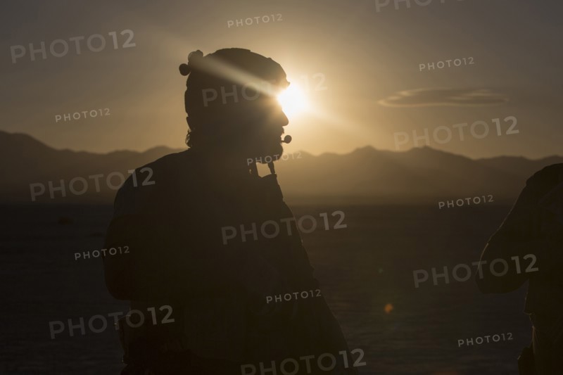 Silhouette of soldier standing in desert landscape