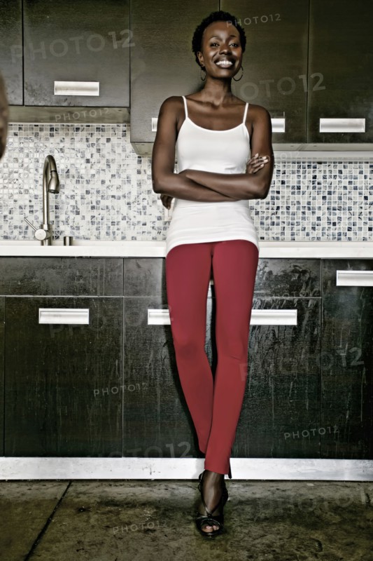Black woman smiling in kitchen