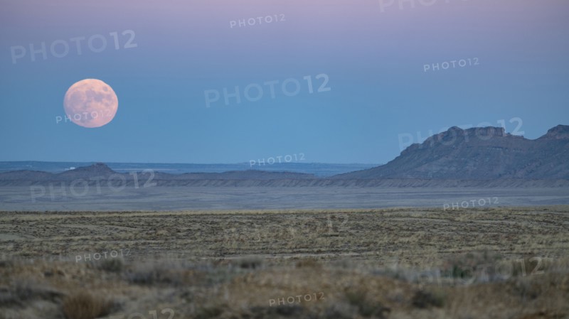 Full moon rising over Navajo Nation desert landscape