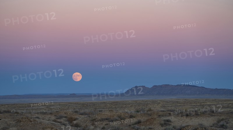 Full moon rising over Navajo Nation desert landscape