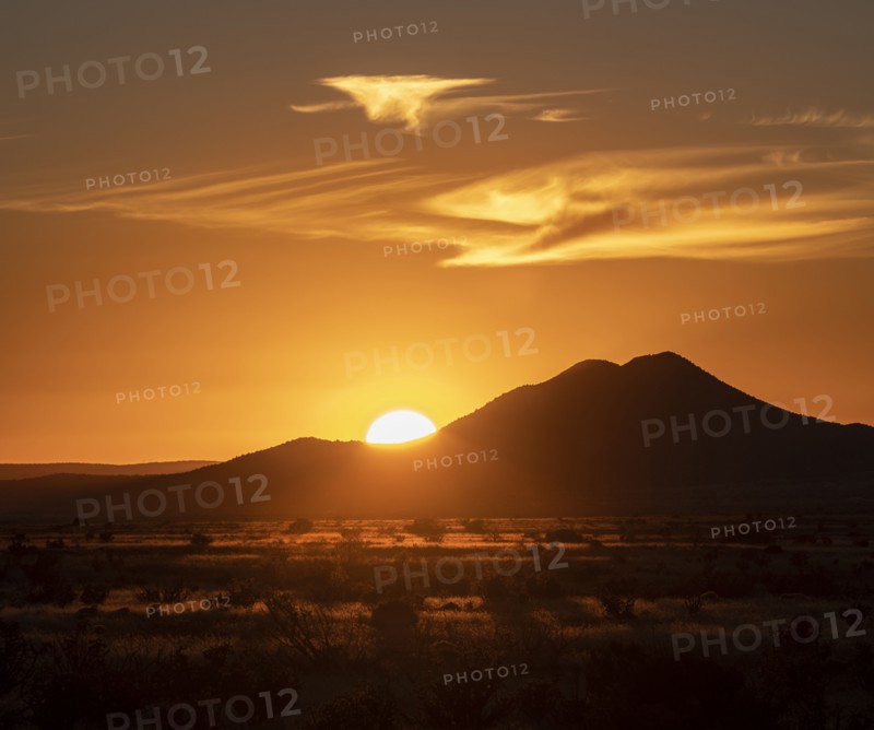 Sun setting above hill in Cerrillos Hills State Park