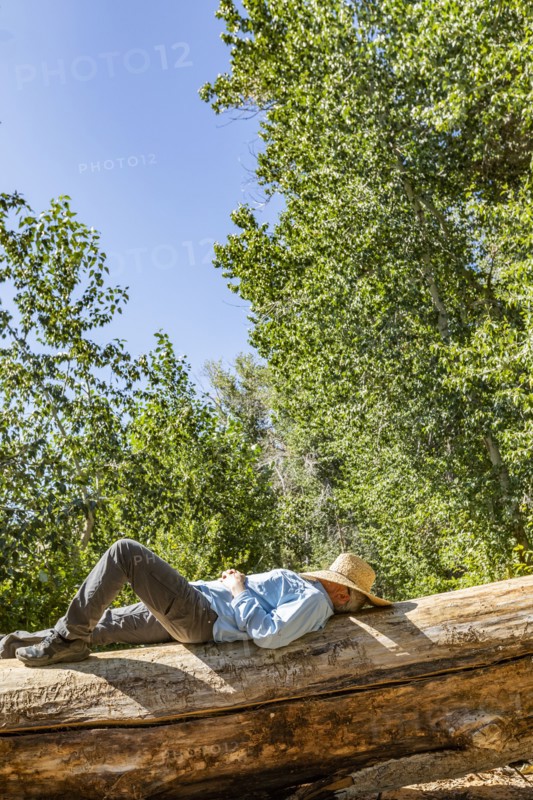 Man with straw hat on face