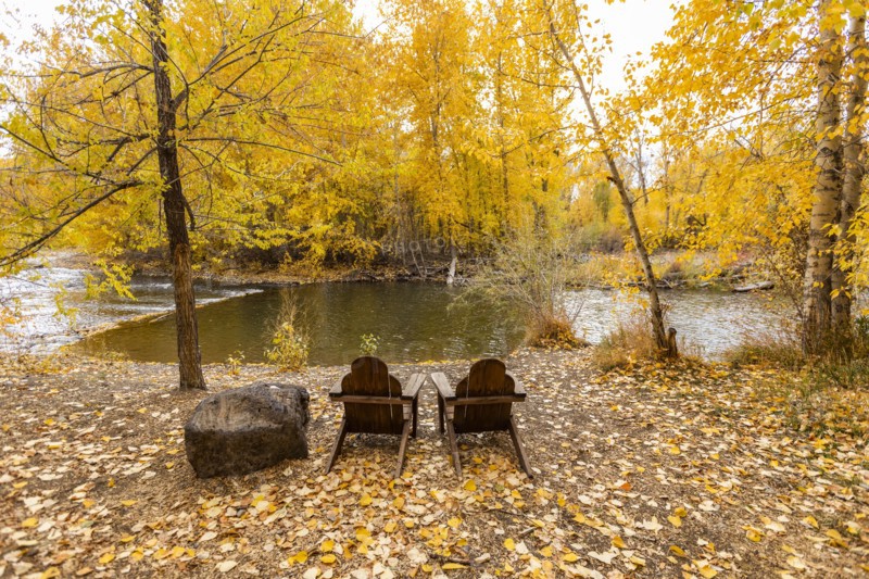 Two adirondack chairs facing Big Wood River