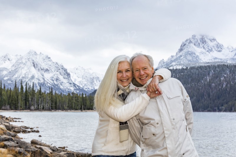 Portrait of smiling senior couple at mountain lake