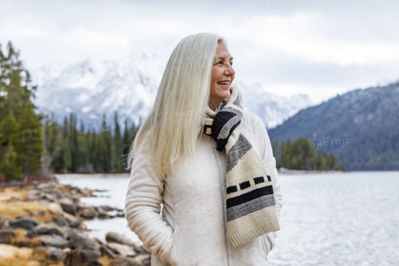 Smiling senior woman at mountain lake