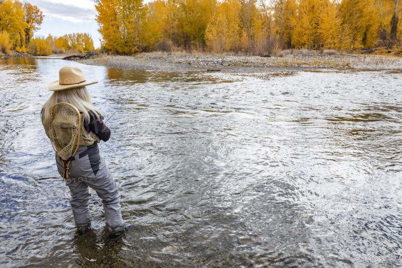 Senior woman fly-fishing