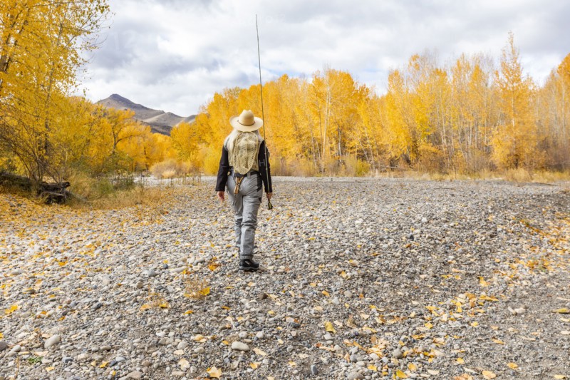 Senior woman fly-fishing