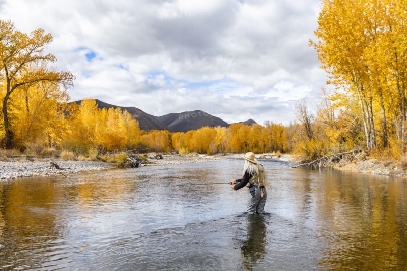Senior woman fly-fishing