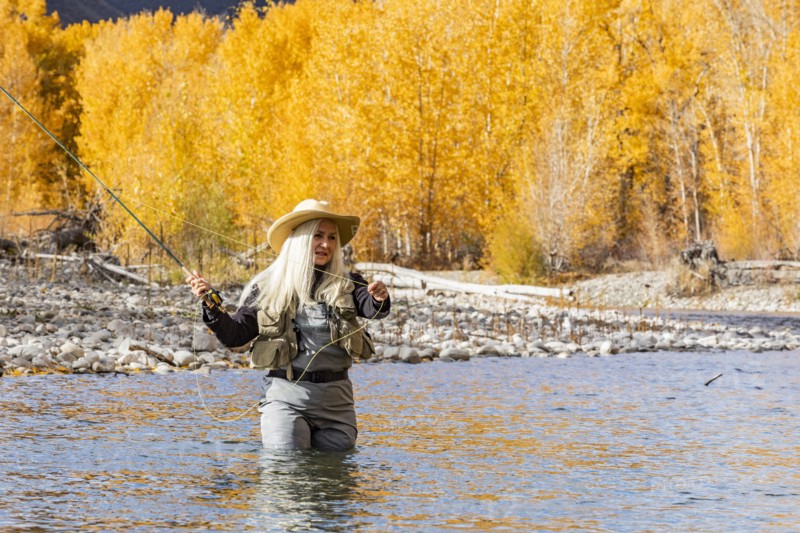 Senior woman fly-fishing