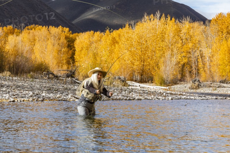 Senior woman fly-fishing