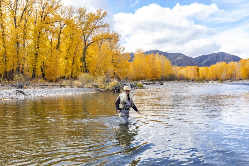 Senior woman fly-fishing
