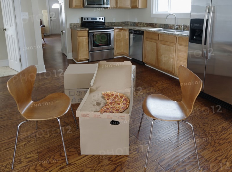 Pizza break on cardboard boxes during house move