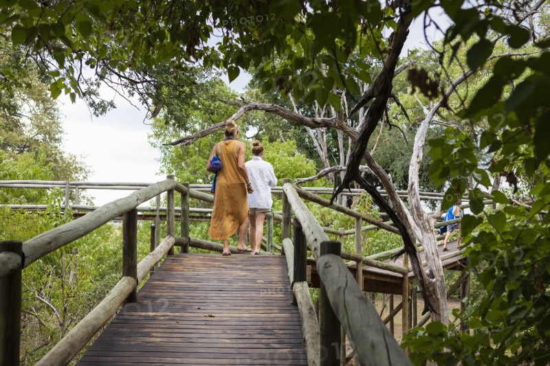 Mother and daughter on wooden walkway
