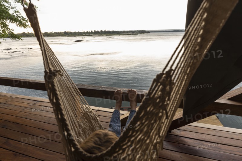 Boy relaxing in hammock by Zambezi River