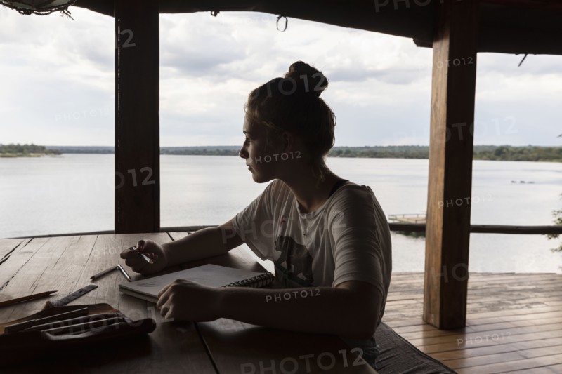 Girl relaxing in lodge by Zambezi River