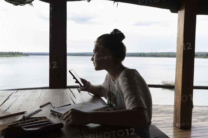 Girl relaxing in lodge by Zambezi River