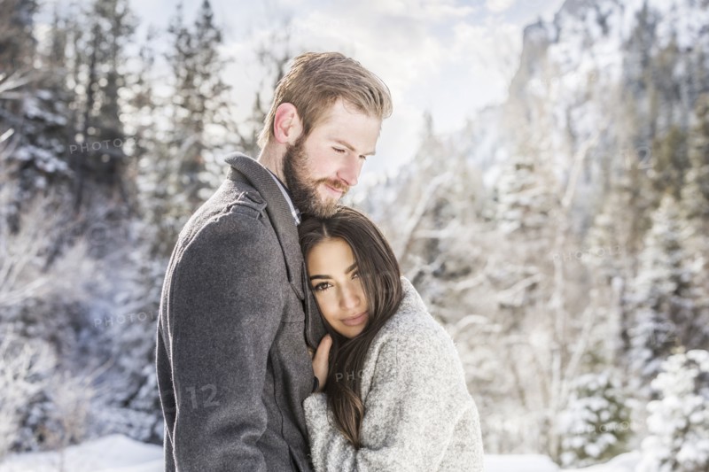 Couple hugging in Winter landscape