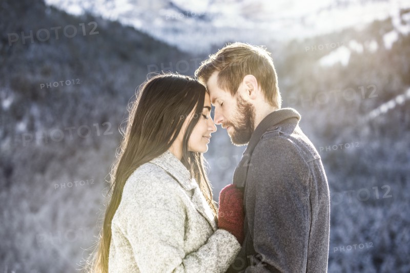 Couple hugging in Winter landscape