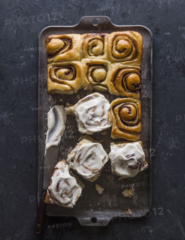 Overhead view of freshly baked cinnamon buns on baking sheet