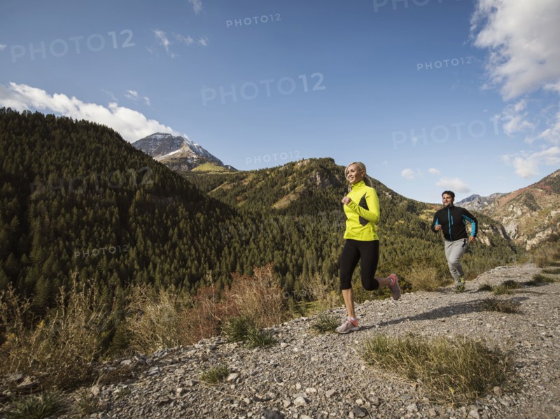 Couple jogging in mountain landscape