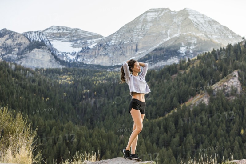 Athlete woman looking at view in mountain landscape