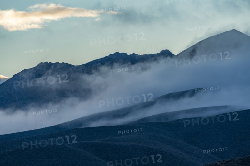 Fog rolling over foothills at dusk