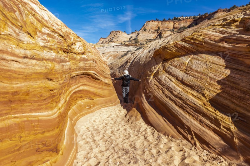 Senior hiker walking in sandstone canyon