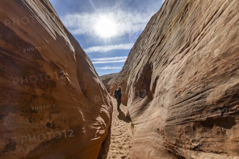 Senior hiker walking in sandstone canyon