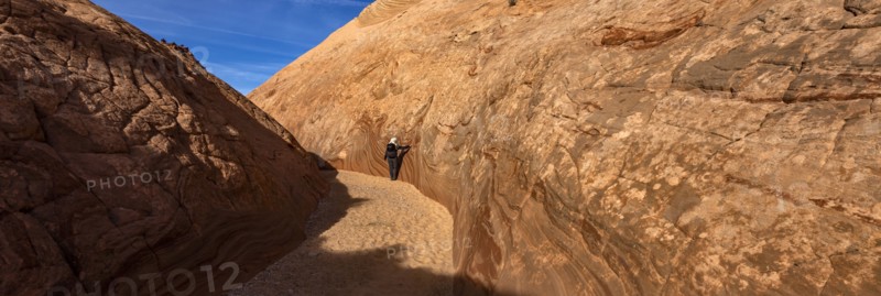 Senior hiker walking in sandstone canyon