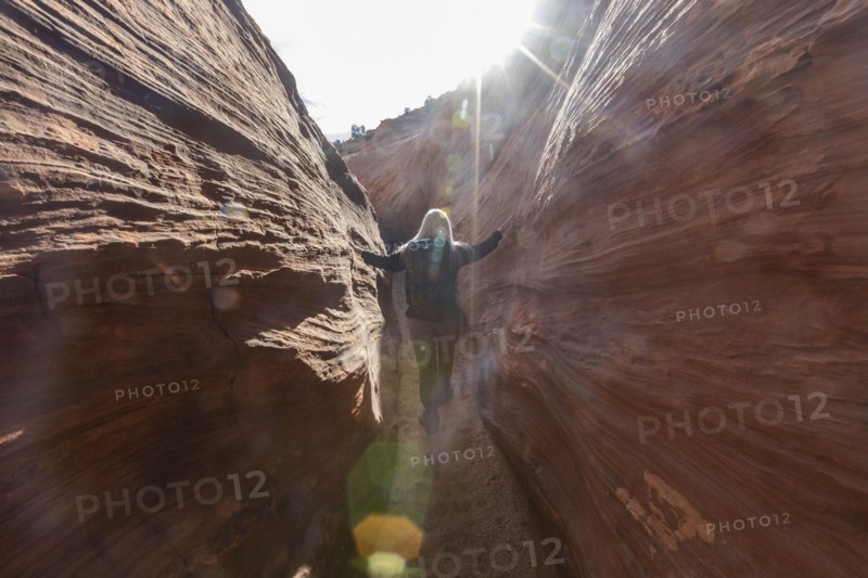 Senior hiker exploring slot canyon
