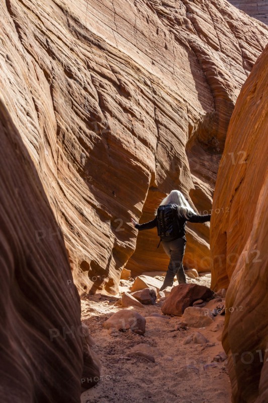 Senior hiker exploring slot canyon
