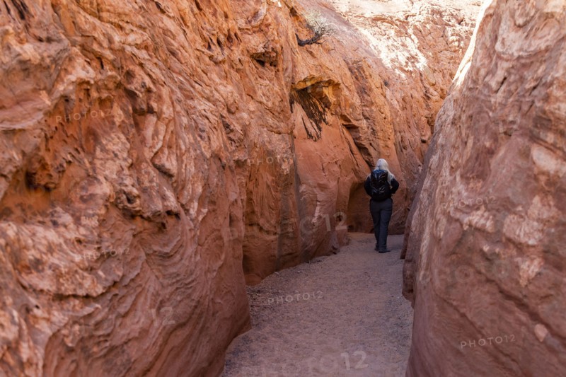 Senior hiker exploring slot canyon