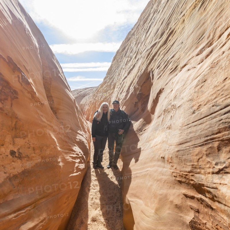 Senior hiker couple exploring slot canyon