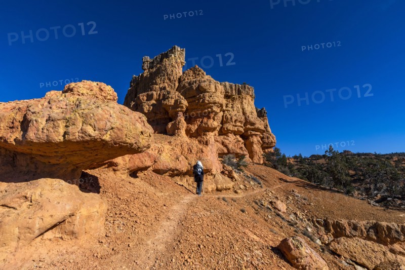 Senior hiker walking in rocky landscape