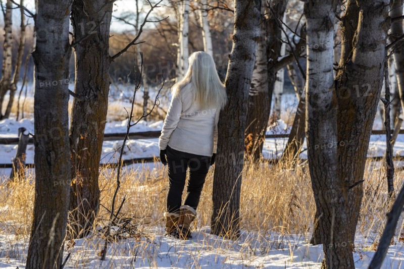 Senior woman posing in winter forest