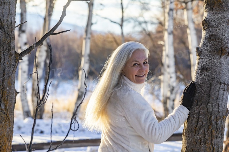 Senior woman posing in winter forest
