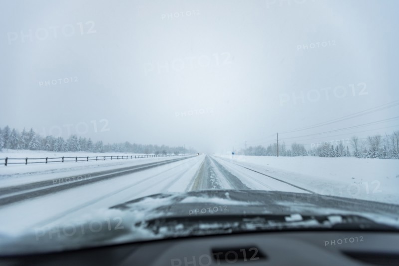 Snowstorm on highway seen from car
