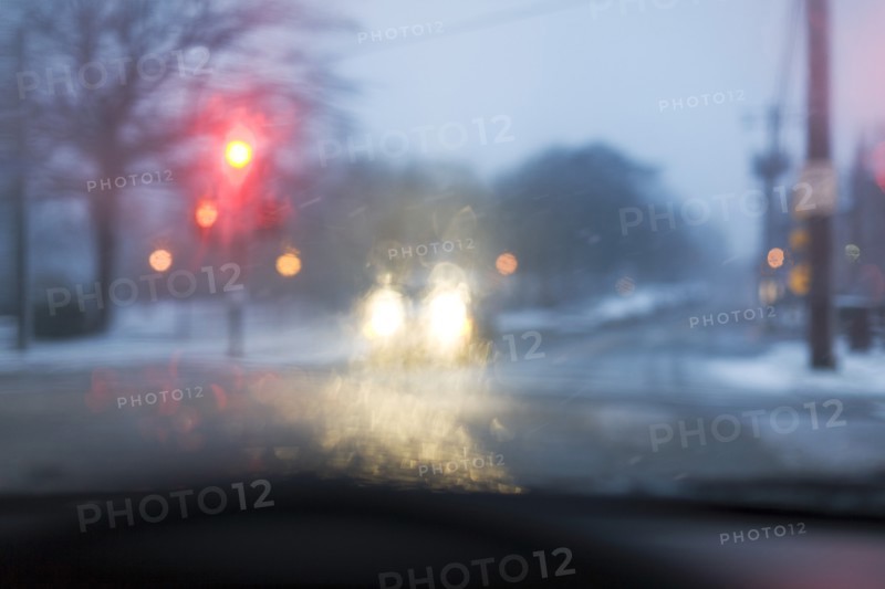 Street seen from car during snowstorm
