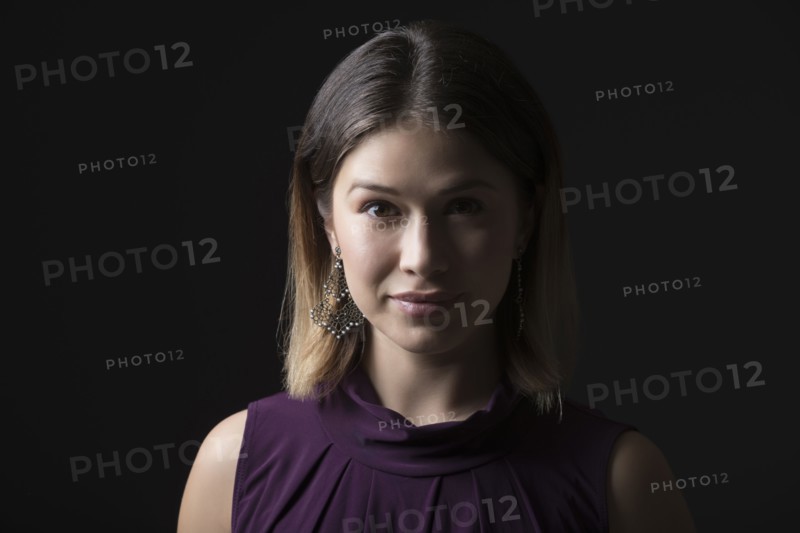 Studio portrait of woman in sleeveless purple top